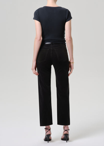 Person wearing a black t-shirt and black pants on a grey background