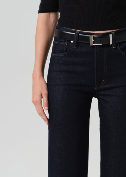 Close up of dark blue jeans on a grey background
