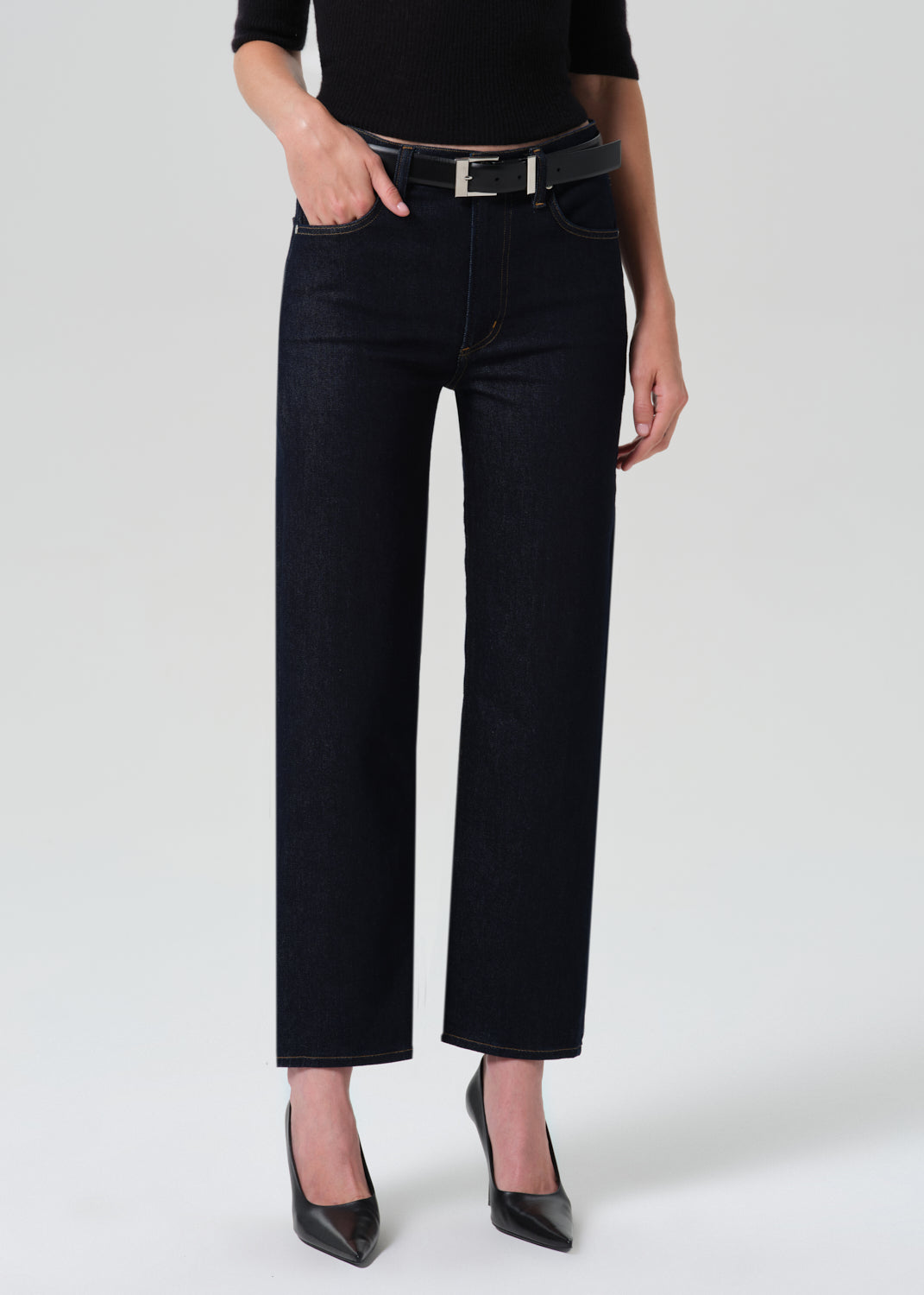 Close up shot of dark blue jeans on a grey background