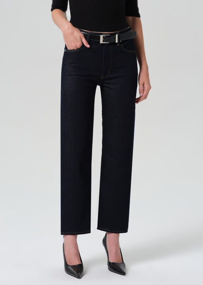 Close up shot of dark blue jeans on a grey background
