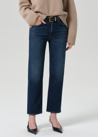 Close up shot of dark blue pants on a grey background