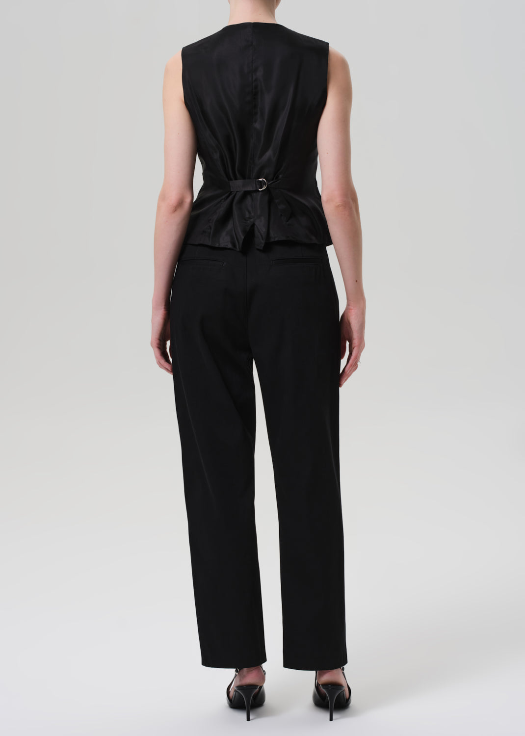 Black sleeveless top and pants set on a white background