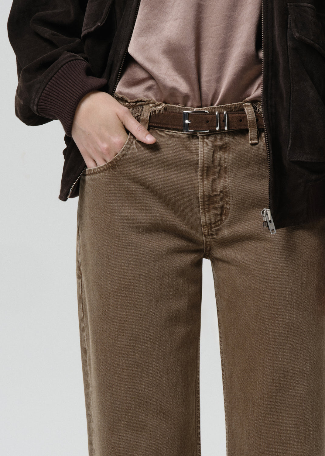 Brown pants with a belt on a grey background