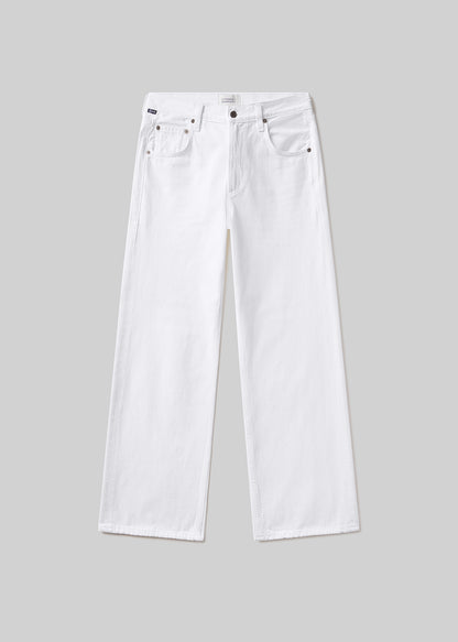 White wide-leg denim jeans with a five-pocket design, belt loops, and button and zipper closure, front flat lay view on a grey background.