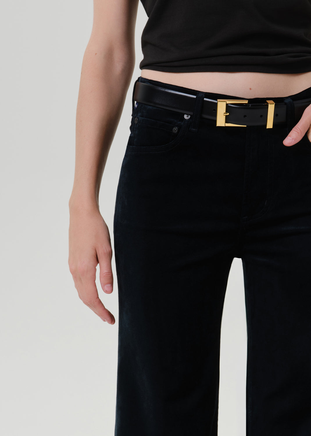 Close-up of black wide leg pants on a grey background