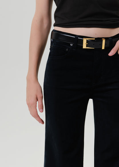 Close-up of black wide leg pants on a grey background