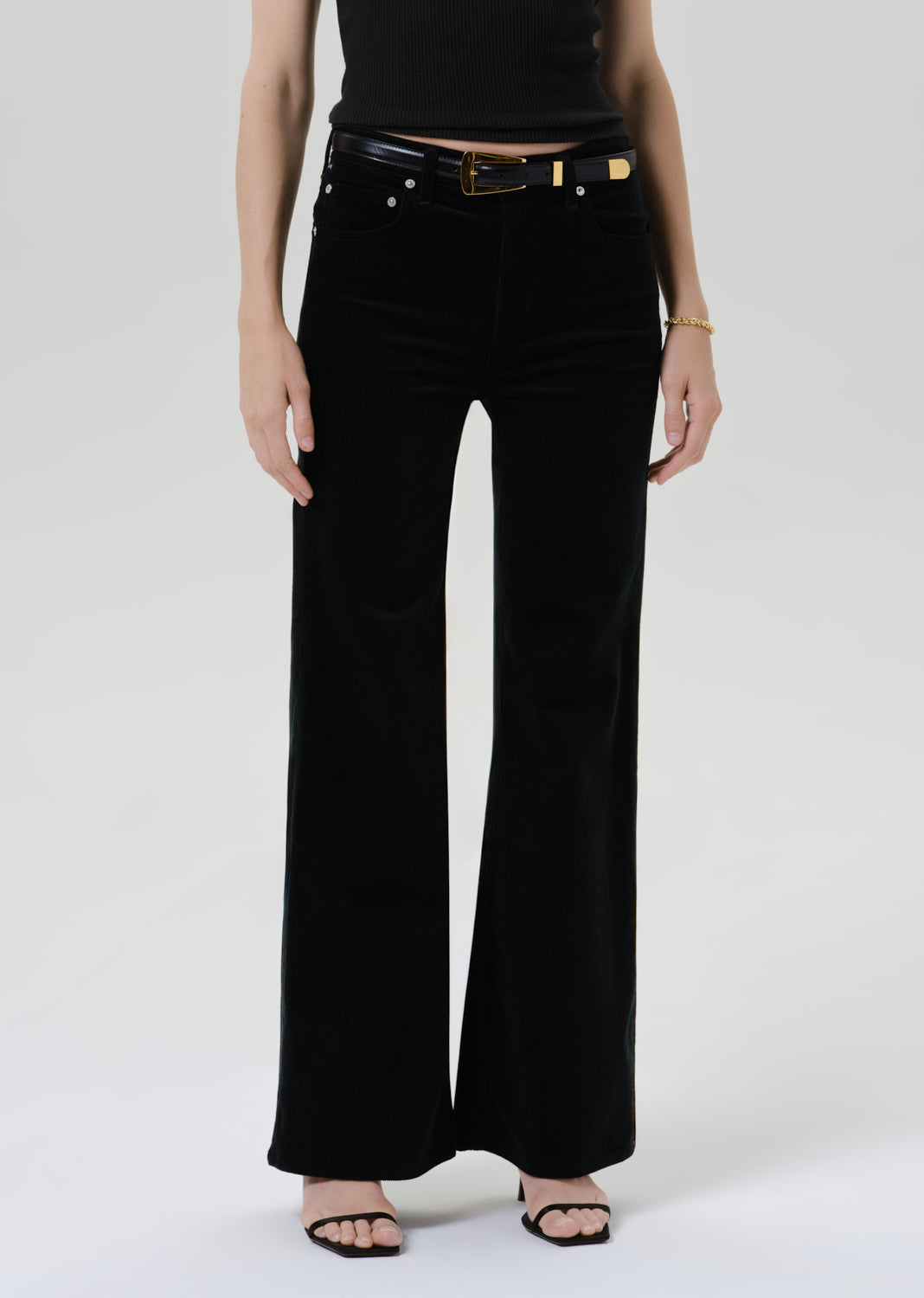 Close up of black pants on a grey background