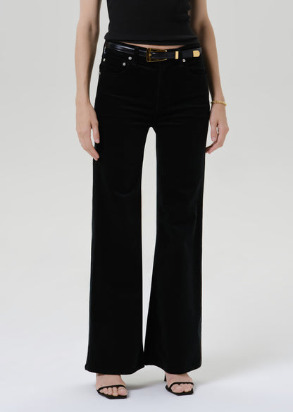 Close up of black pants on a grey background