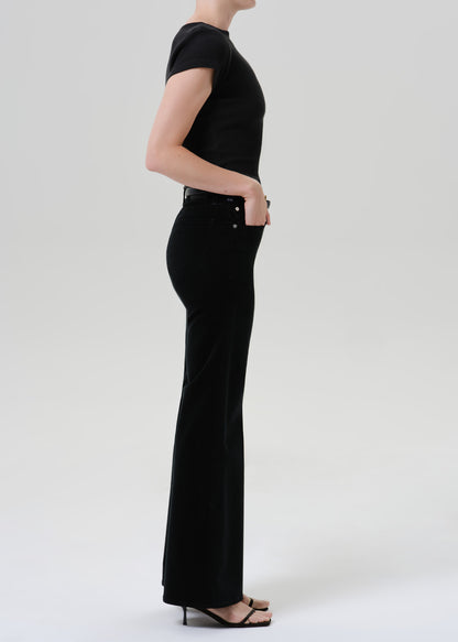 Person wearing a black outfit on a grey background