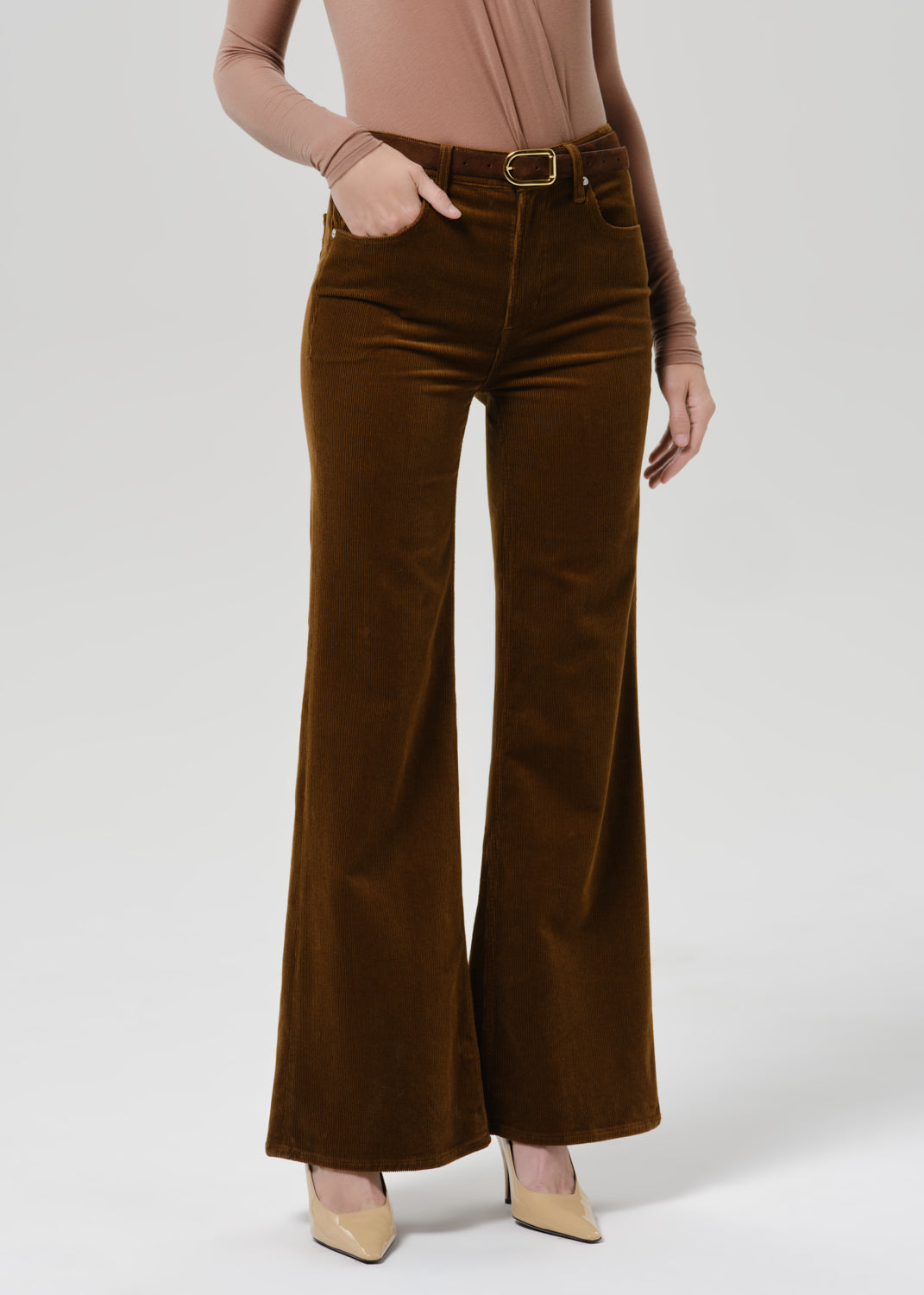 Close up of orange flare corduroy pant on a grey background