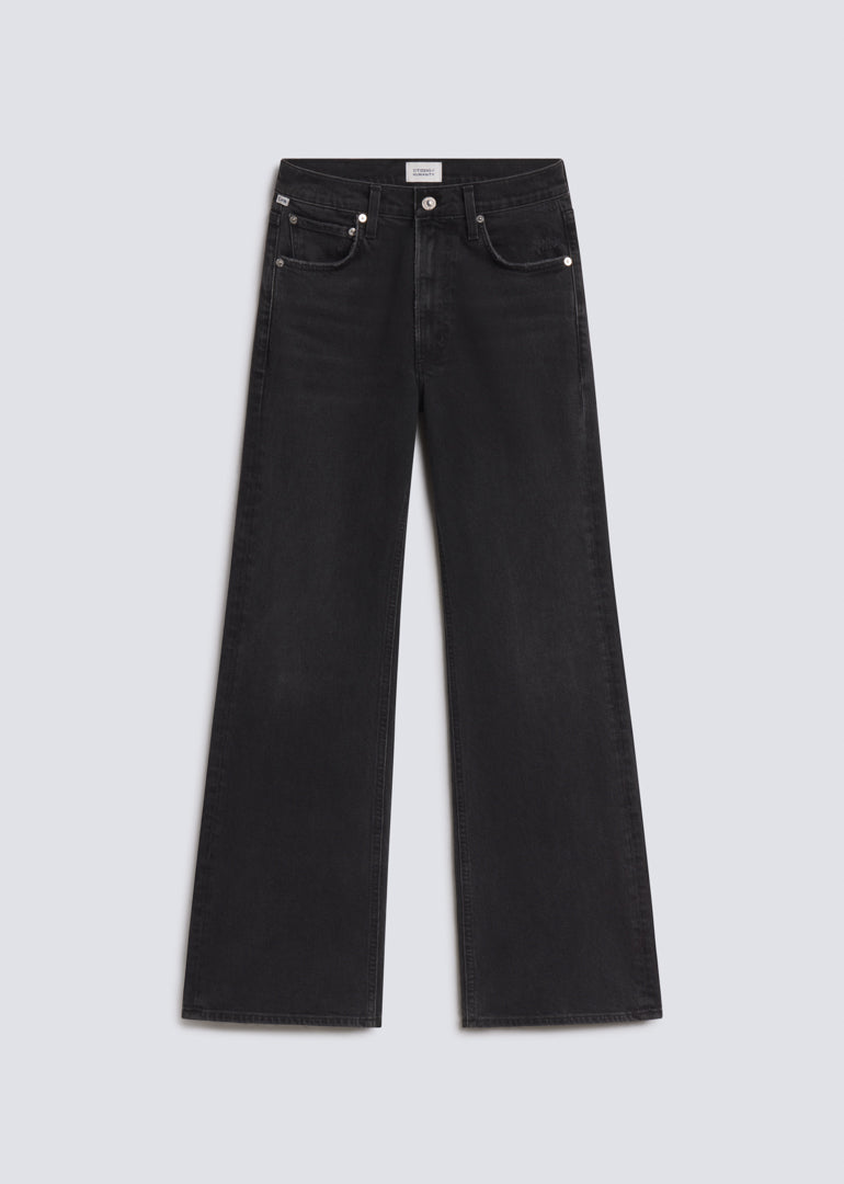 Kimberly 70s Flare in Cateye, featuring washed black denim with subtle fading, a fitted upper leg, flared silhouette, and classic five-pocket design, front view on a grey background.