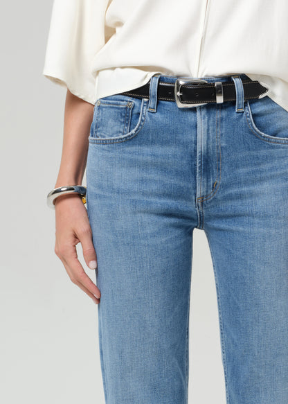 Person wearing blue jeans with a white background