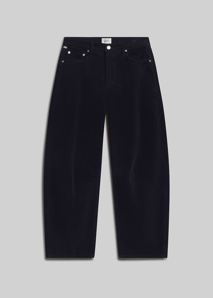 Navy corduroy barrel-leg jeans on grey background