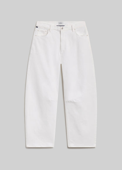 White barrel-leg jeans on grey background