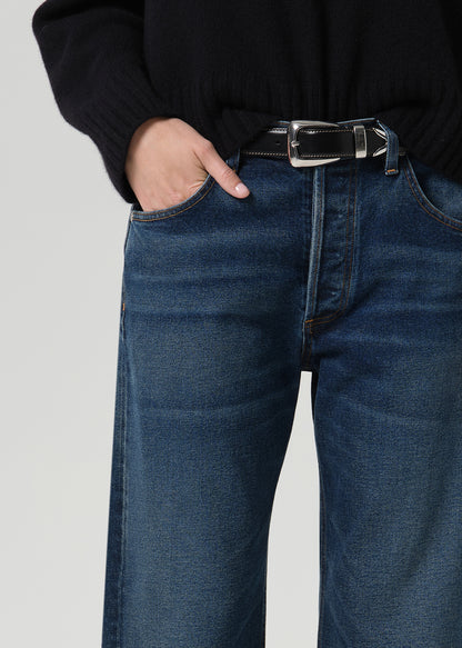 Person wearing dark indigo jeans paired with sweater