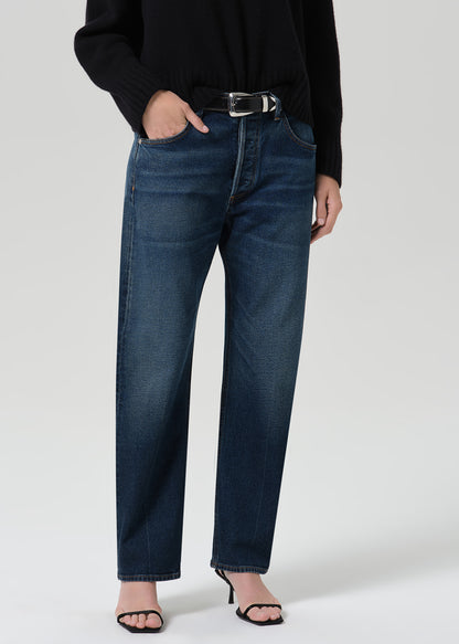 Person wearing dark indigo jeans paired with sweater