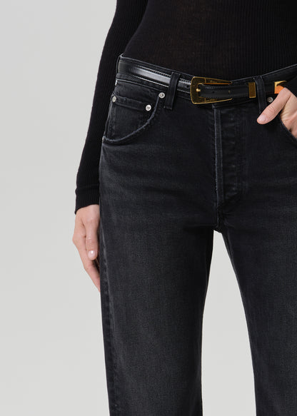 Person wearing washed black jeans paired with black turtleneck