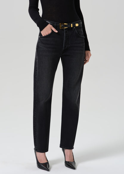 Person wearing washed black jeans paired with black turtleneck