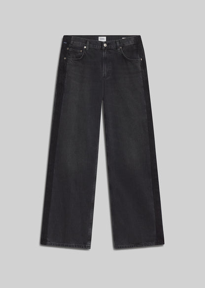 Black tuxedo-stripe wide-leg jeans on grey background
