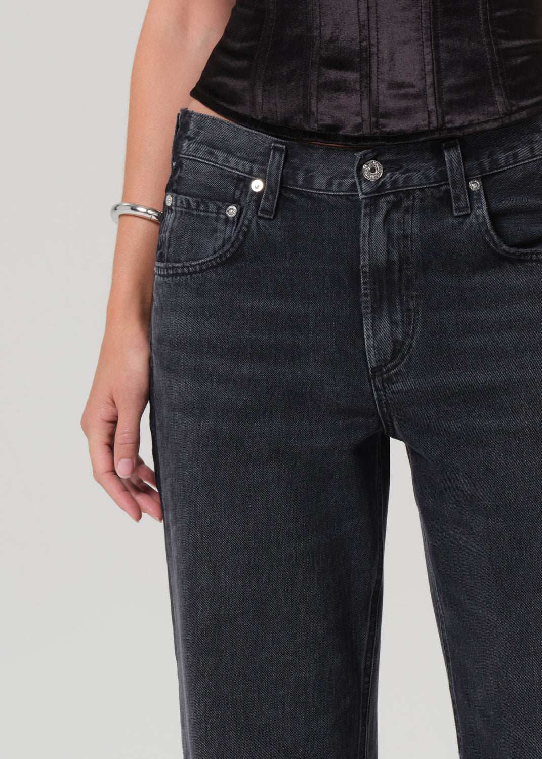 Black jeans worn by a person on a light gray background