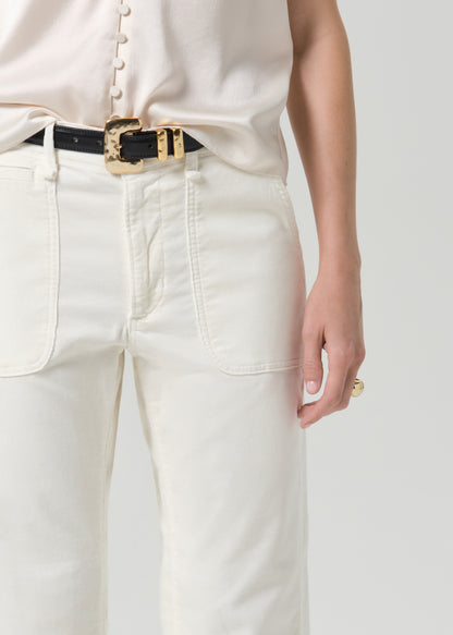 Close up of white pant and black belt on a grey background