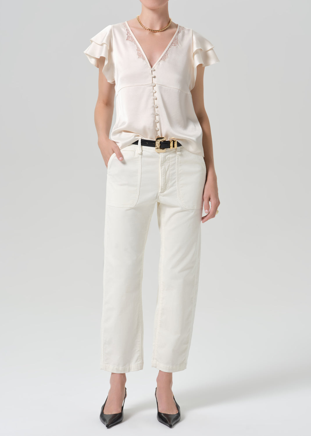 Person wearing a white outfit on a grey background