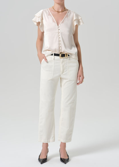 Person wearing a white outfit on a grey background
