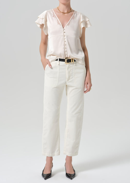 Person wearing a white outfit on a grey background