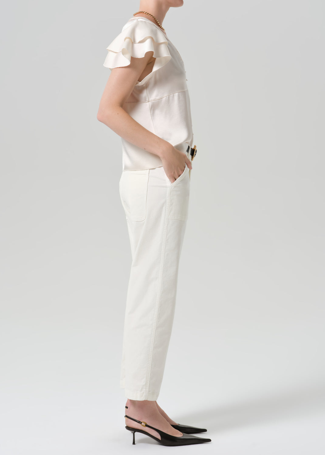 Person wearing a white outfit on a grey background