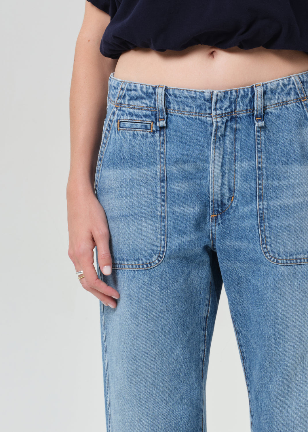 Close-up of blue jeans with a plain background