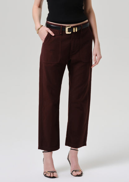 Brown pants worn by a person on a grey  background