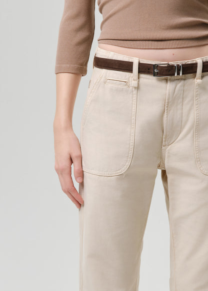 Beige pants with a brown belt on a grey background