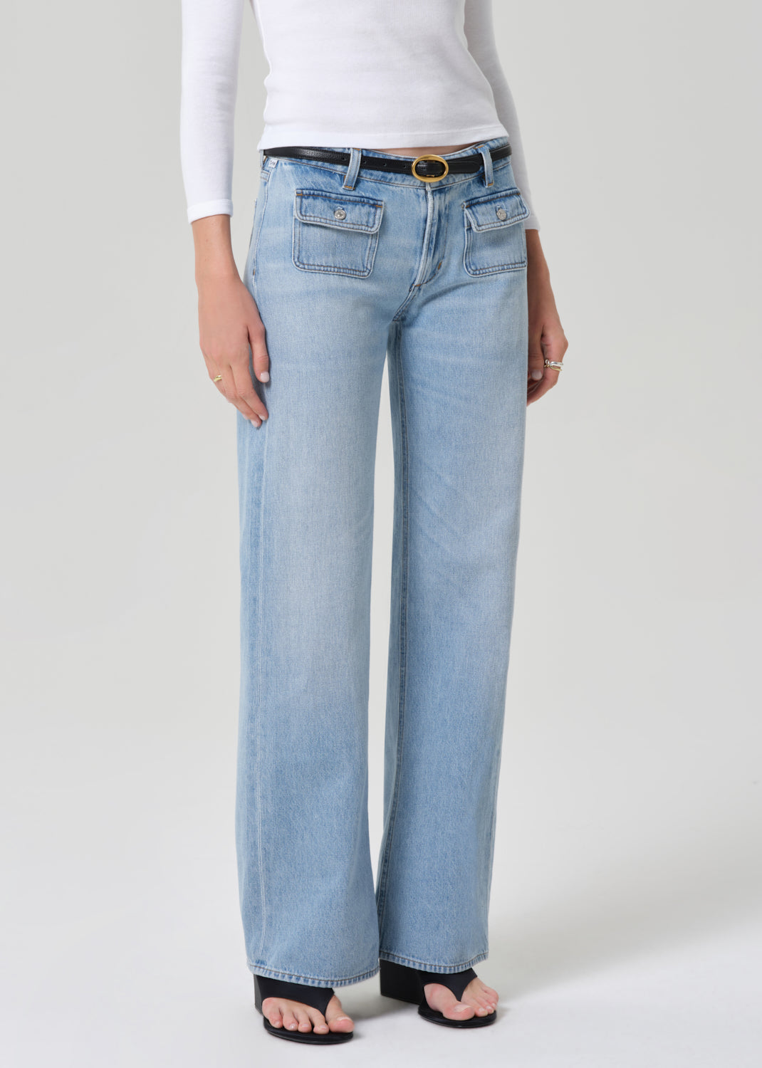Light blue jeans worn by a person on a white background