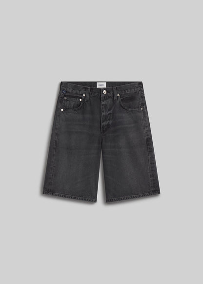 Vintage black denim Bermuda shorts on grey background