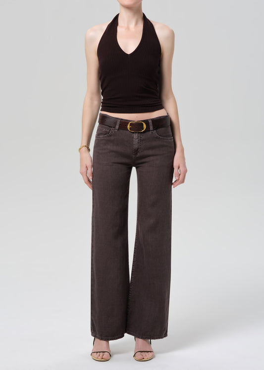 Person wearing a dark brown halter top and charcoal wide-leg linen pants on a plain background 
