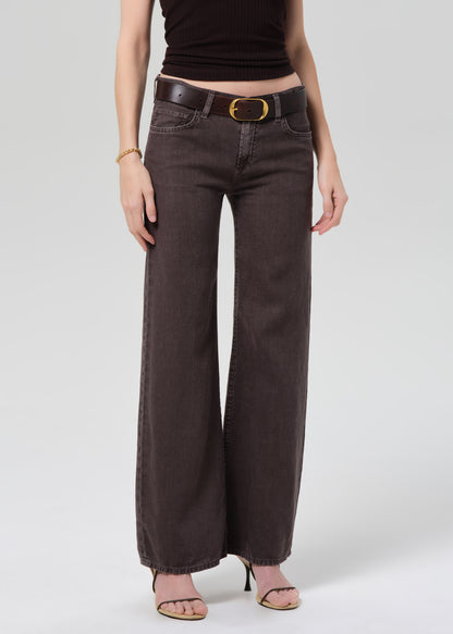 Person wearing a dark brown halter top and charcoal wide-leg linen pants on a plain background 