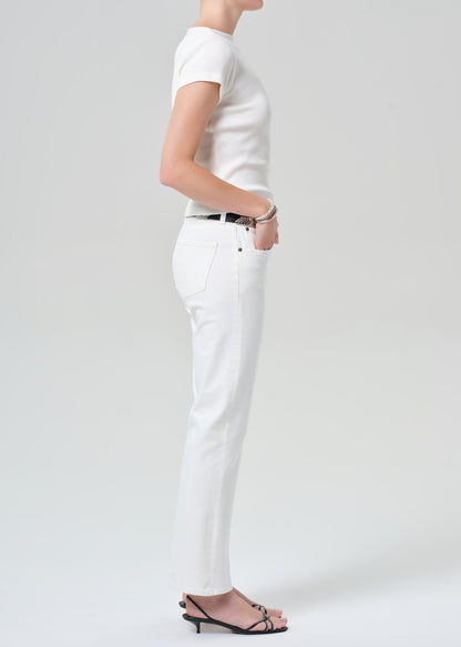 Person wearing a white t-shirt and white pants on a plain background