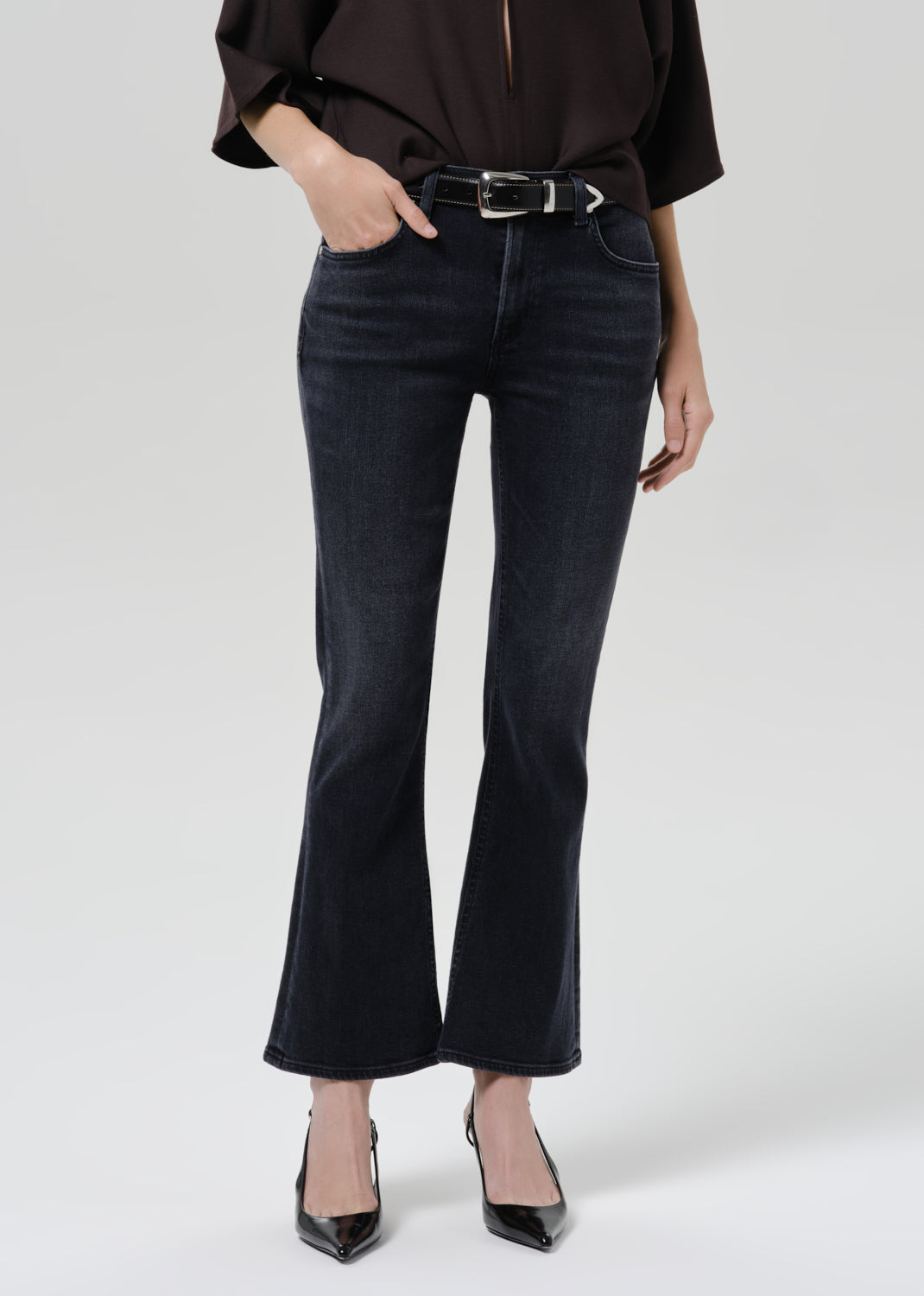 Close up of blue jeans on a grey background