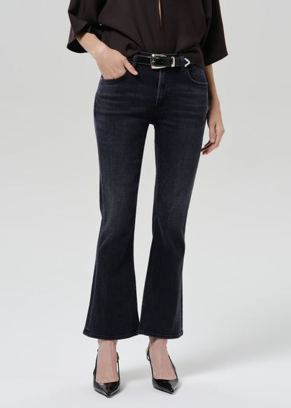 Close up of blue jeans on a grey background