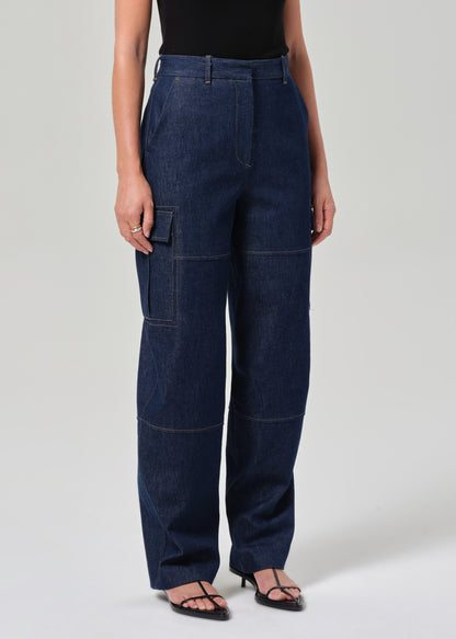 Person wearing dark blue cargo pants on a plain background