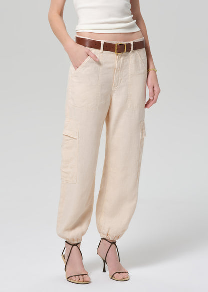 Beige pants worn by a person on a white background