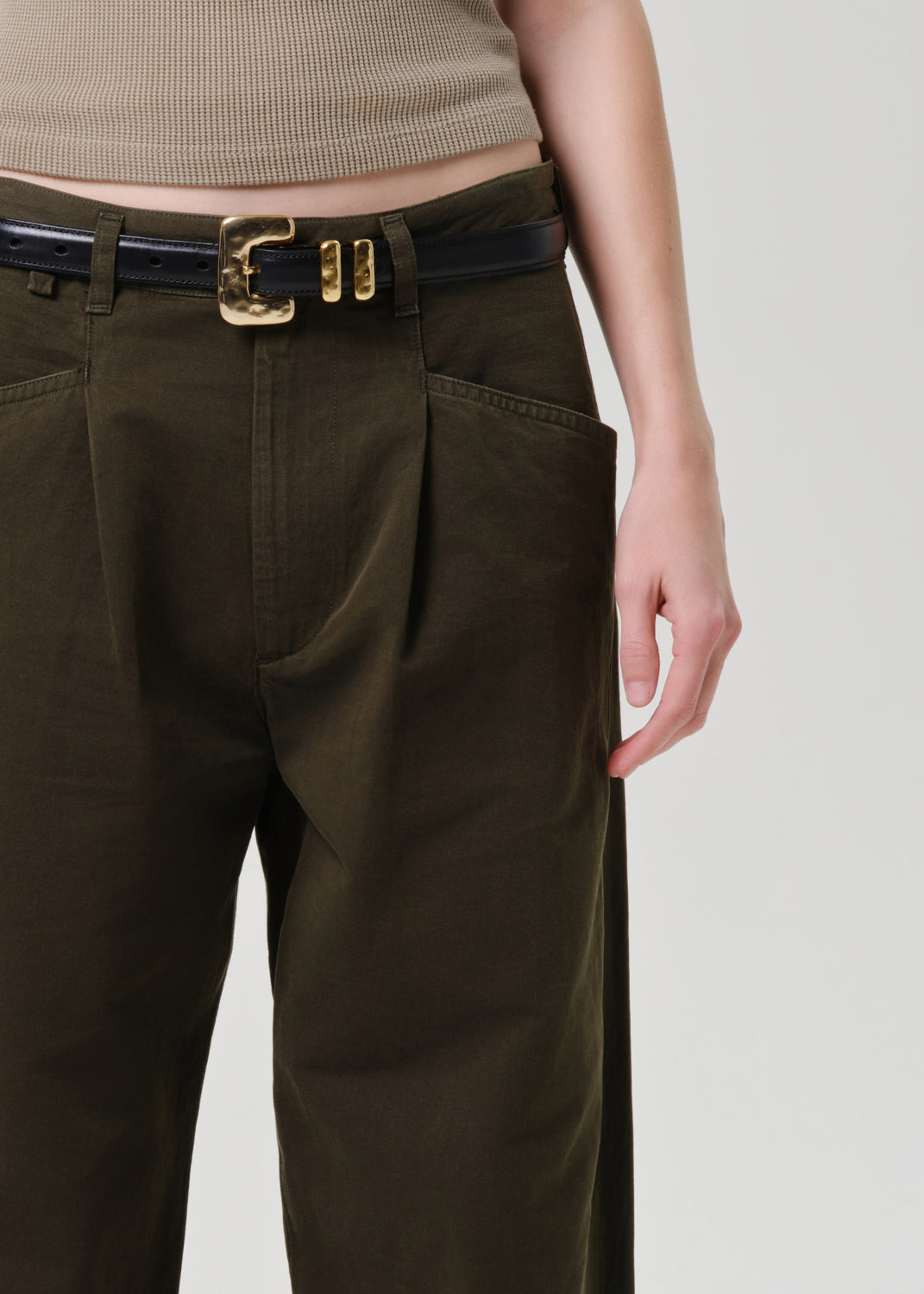 Brown pants with a belt on a grey background