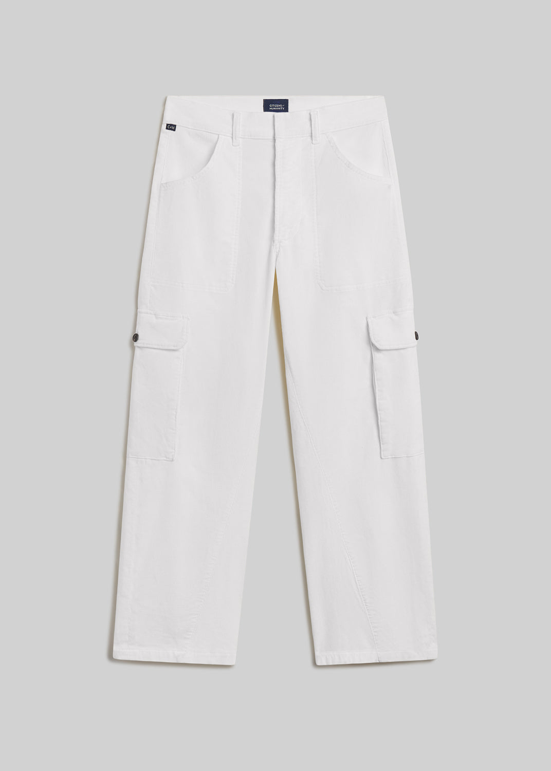 Pashmina white wide-leg utility pants with front patch pockets, side cargo pockets, twisted seam detailing, belt loops, and button closures, front flat lay view on a grey background.