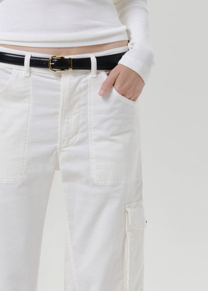 Close up of white pants and black belt on a grey background