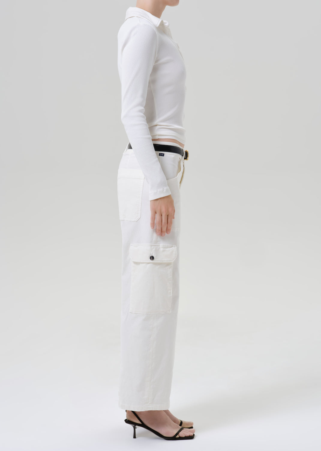 Person wearing white outfit on a grey background