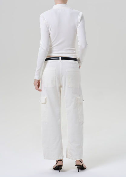 Person wearing white outfit on a grey background