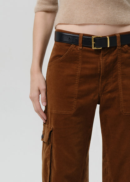 Brown cargo pants with a black belt on a grey background