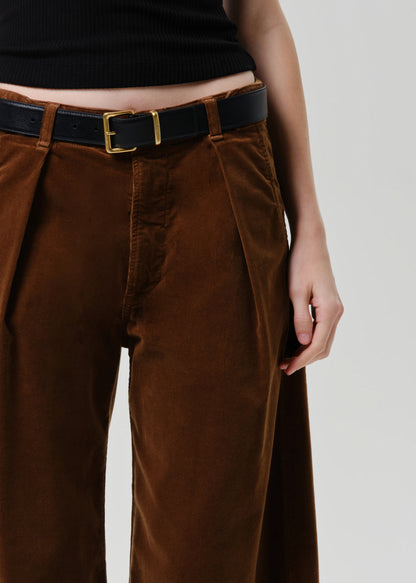 Brown wide-leg pants with a black belt on a grey background