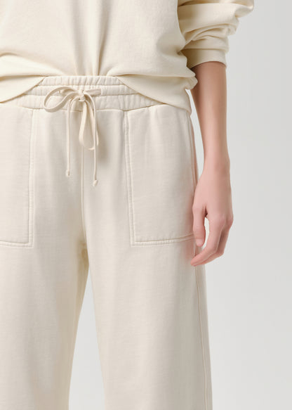 Beige pants with a drawstring waist on a grey background