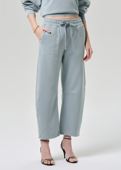 Light blue pants worn by a person on a grey background